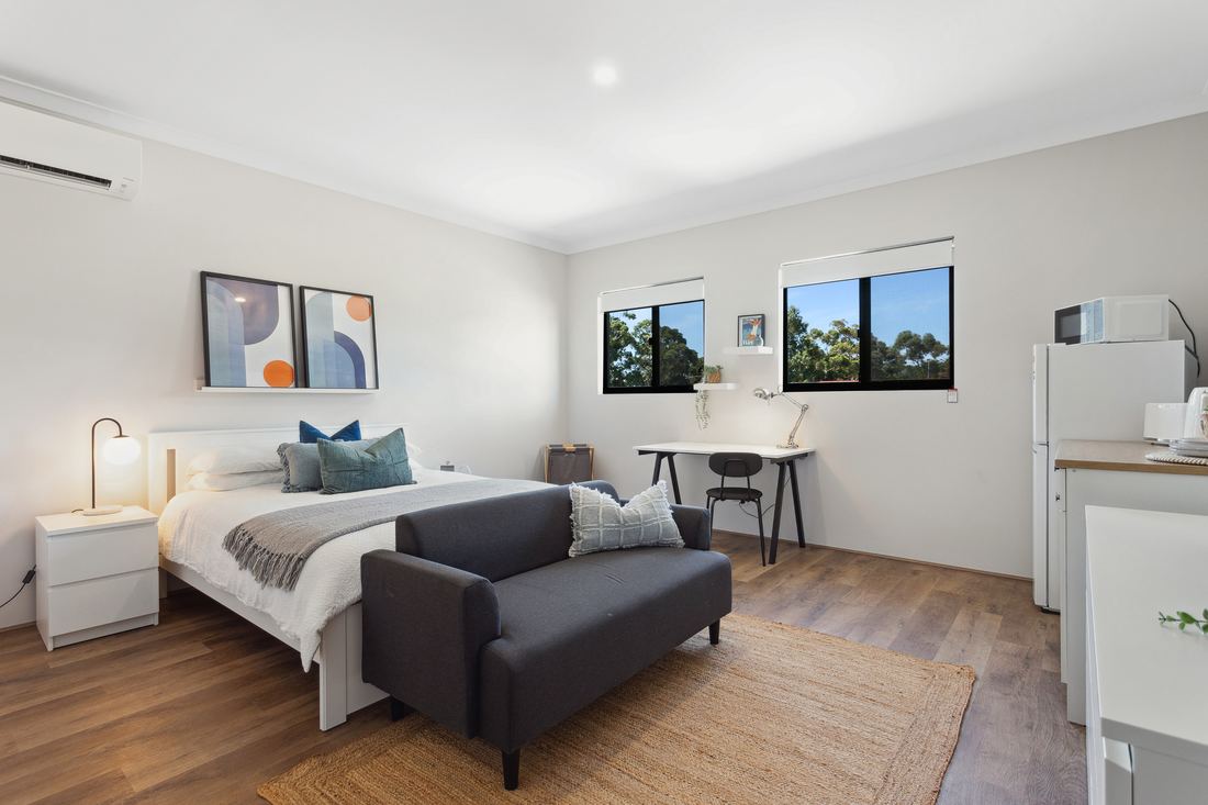 Self-contained room with bed, sofa, desk and kitchenette